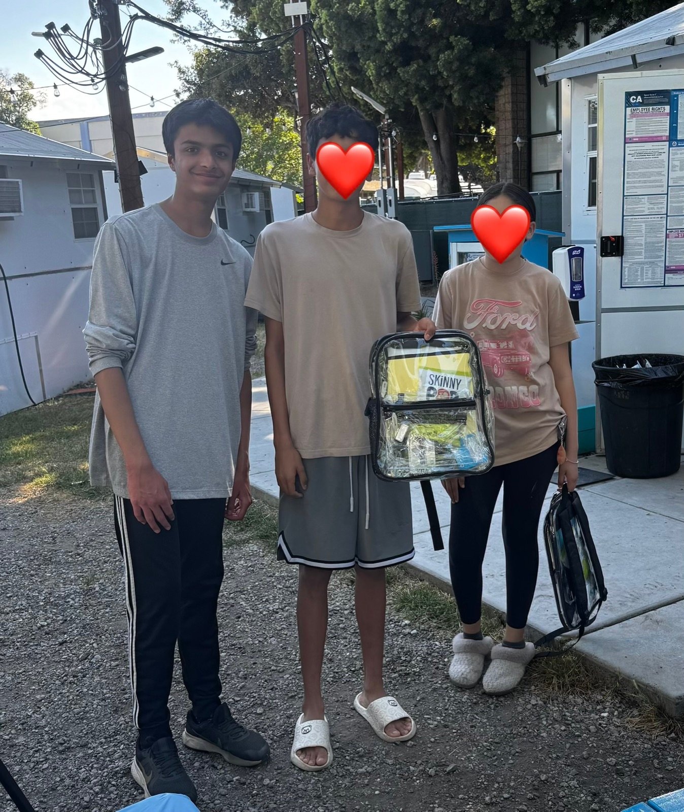 Volunteers outside with a packed Smile Bag backpack